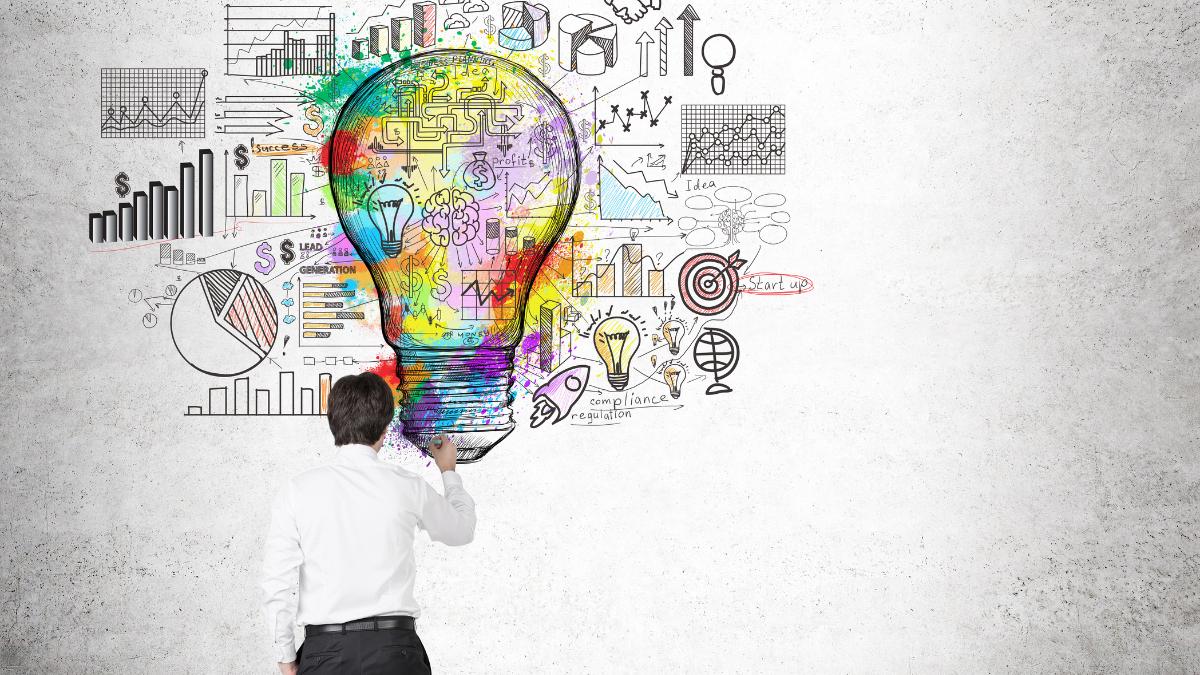 Abstract image of a colorful lightbulb symbolizing creativity and innovation in the workplace, with charts and sketches in the background.