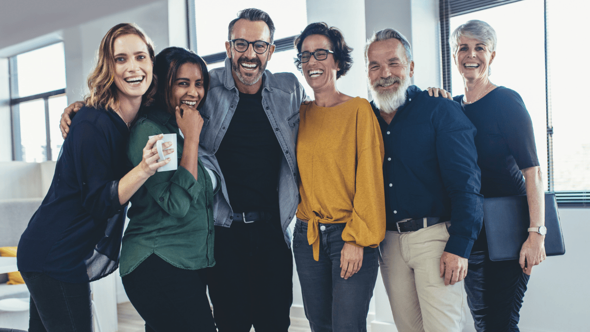 Inclusive and diverse team of professionals standing together in a modern office environment