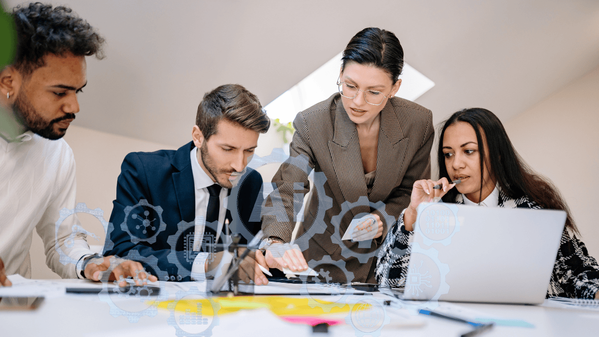 Job seekers collaborating at a table, reviewing documents and discussing AI readiness and skills for today’s job market.