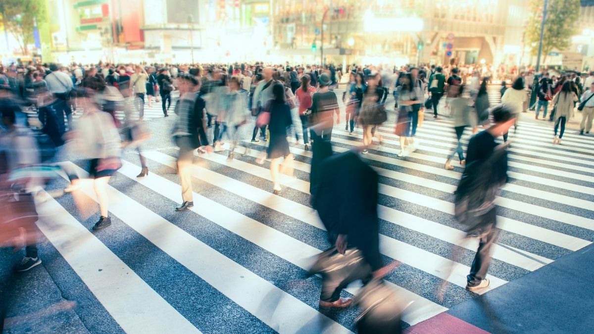 Crowds of workers crossing a busy city intersection, representing Canada's labour market and employment trends in May 2026.