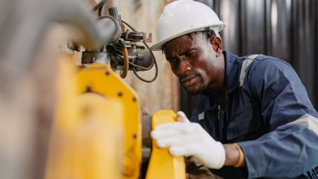 Engineer working on industrial equipment for Hatch engineering opportunities in Canada